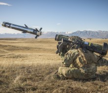 Soldier crouched down firing javelin missile
