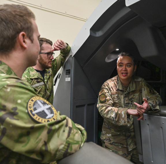 An instructor from Detachment 4 of the 373rd Training Squadron showcases an aircraft training simulator to Royal New Zealand Air Force maintainers (U.S. Air Force photo by Airman 1st Class Isabell A. Nutt)