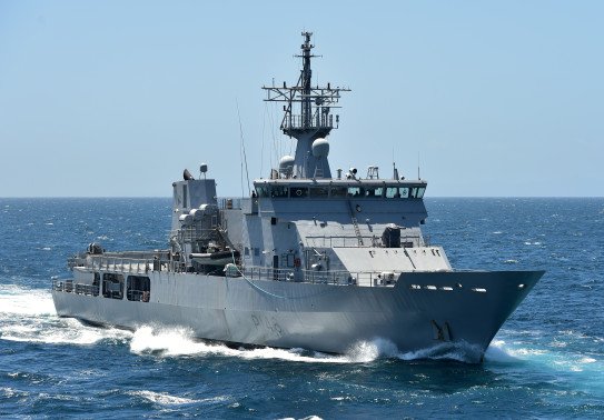 Royal New Zealand Navy's HMNZS Otago sailing on the ocean on a nice day with blue sky. 