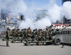 Many New Zealand Army soldiers fire the L119, 105mm Light Guns on the Wellington Waterfront on a nice day. 
