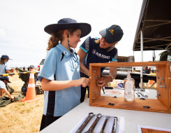 A member of the School to Skies on the Road team shows a student some of the equipment. 