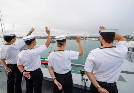 Royal New Zealand Navy sailors wave from HMNZS Aotearoa arriving into New Plymouth. 