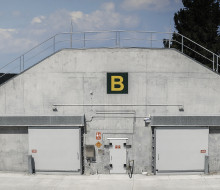 Glenntunnel Ammunition Depot. A concrete bunker-like structure juts out of a hillside.