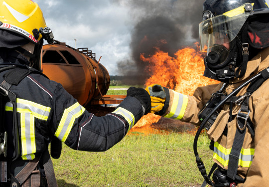 Royal New Zealand Air Force and U.S. Air Force firefighters fist bump prior to conducting a joint live-fire training exercise during Mobility Guardian 23 at Andersen Air Force Base, Guam. 