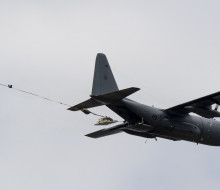 A pallet falls from a C-130H(NZ) Hercules in flight after parachute extraction during a training exercise.