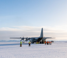 A Royal New Zealand Air Force C-130 Hercules in Antarctica sitting on the ice. 