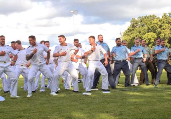 Personnel from the Royal New Zealand Navy, New Zealand Army and Royal New Zealand Air Force perform a haka at the Dave Gallaher Field.