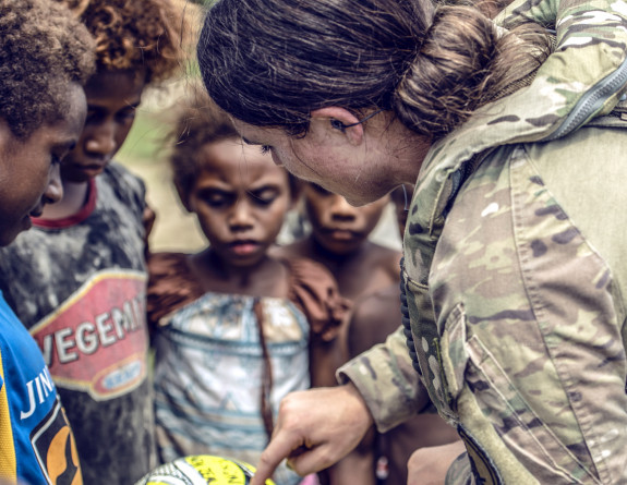 An NH90 Helicopter Loadmaster engages with locals while on duty in the Solomon Islands. No. 3 Squadron were an integral part of the logistical support offered as part of the National Government Elections, OP MOA.