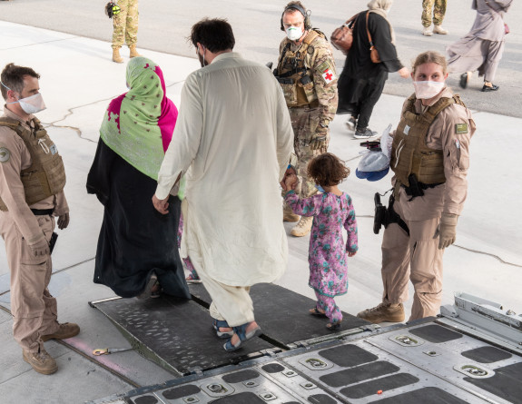 Evacuees from Kabul arrive onboard an Royal New Zealand Air Force C-130H(NZ) Hercules aircraft into Al Minhad Air Base in the United Arab Emirates. 