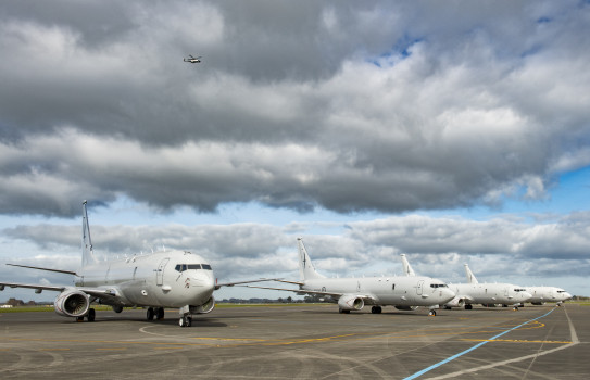 P-8A Poseidon lined up on the flight line, clouds in the sky