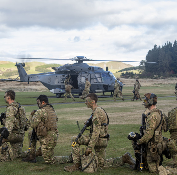 Soldiers from 2nd Engineer Regiment and the Australian Defence Force, along with explosive detection dog ‘Flicker’, wait to board an NH90 before deploying into the field
