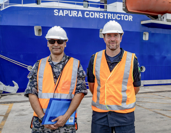 SLT Campbell with RAN Lieutenant Suraj Joshi in front of the MV Sapura after briefing the captain on the exercise.