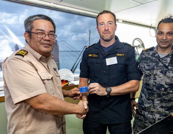 SLT Campbell briefing the captain of the civilian ship Kokopo Chief.