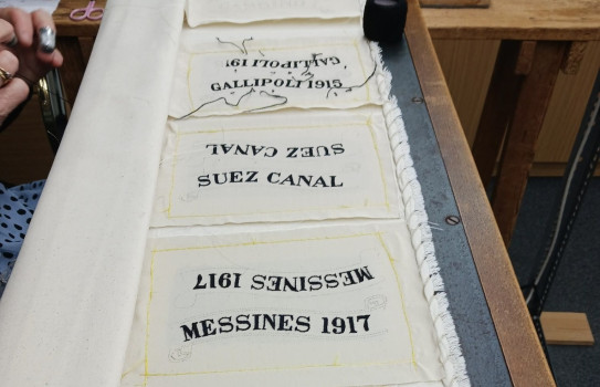 Stitching the battle honours for the Regimental Colour of 2/1 RNZIR