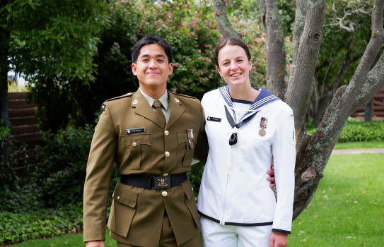 Two NZDF personnel in uniform smiling, looking at the camera. 