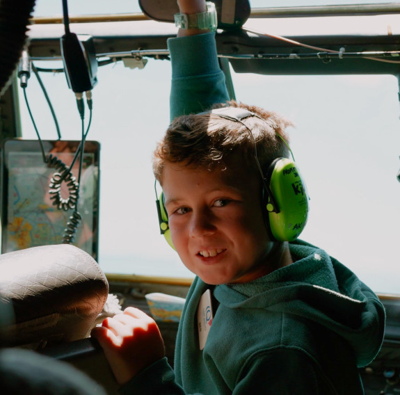 A young boy experiences the cockpit of the C-130H during the flight.