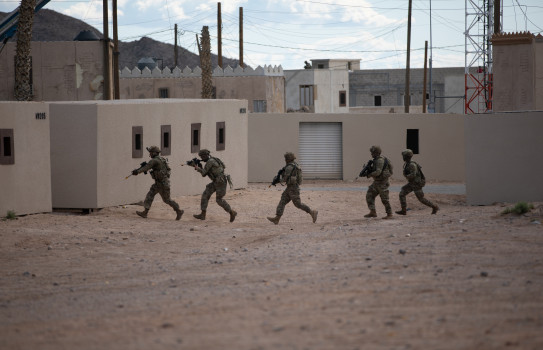 U.S. Army Soldiers with Maneuver Center of Excellence Experimental Company, 1st Battalion, 29 Infantry Regiment, 316th Cavalry Brigade, conduct an urban assault during Human Machine Integration experiments in a training environment - Project Convergence