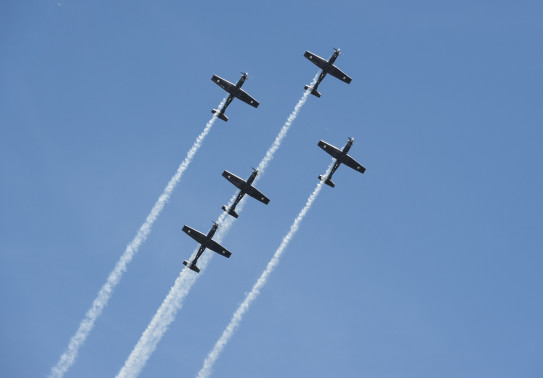 The Black Falcons take to the air during a 2022 display - five aircraft are in formation.
