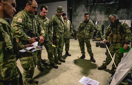 Lance Corporal Gilbert, second from left, listens to orders being given prior to a night exercise in Invercargill