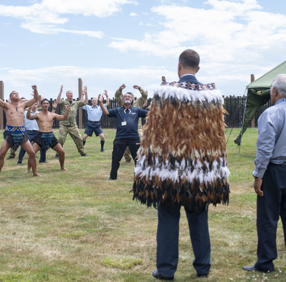 Members of the Royal New Zealand Air Force perform the Air Force haka to welcome Flight Sergeant Thomas Cookson onto RNZAF Tūrangawaewae at Base Ōhakea