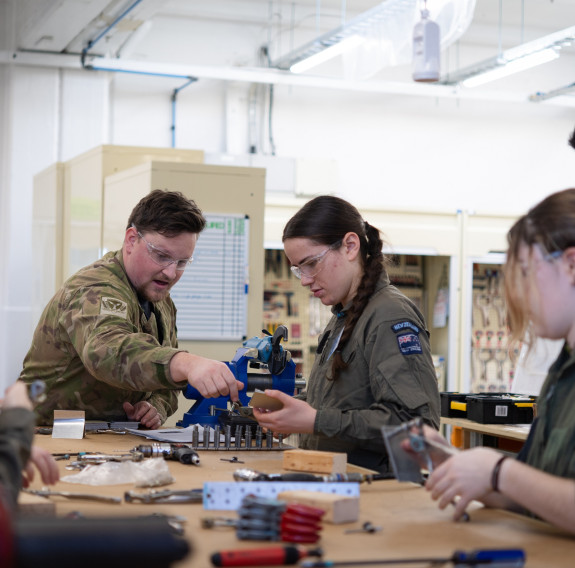 Students are guided by Royal New Zealand Air Force aviators during a session in the workshop.