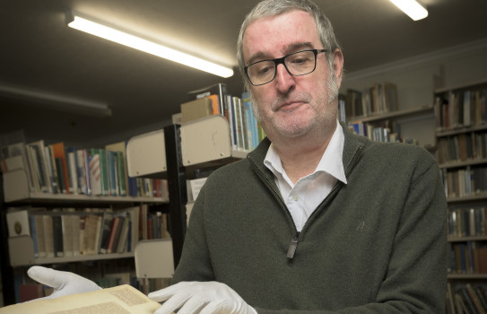 Air Force Museum Research Curator Simon Moody looks through a scrapbook of images compiled by Wing Commander Ralph Cochrane during his service stay in New Zealand from 1936-1939. 