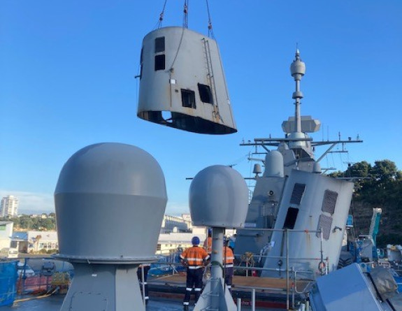 Te Kaha's port funnel is removed by crane in the dry dock.